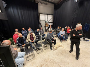 Group of people seated indoors.